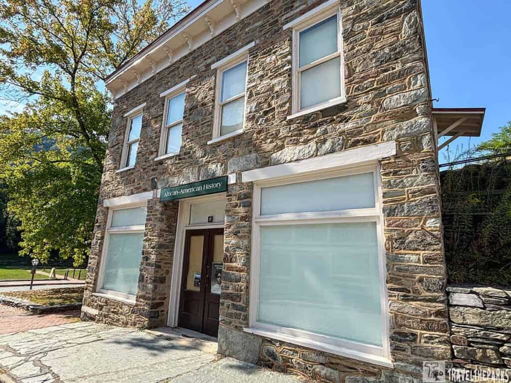 Two-story stone building with a sign reading "African-American History."