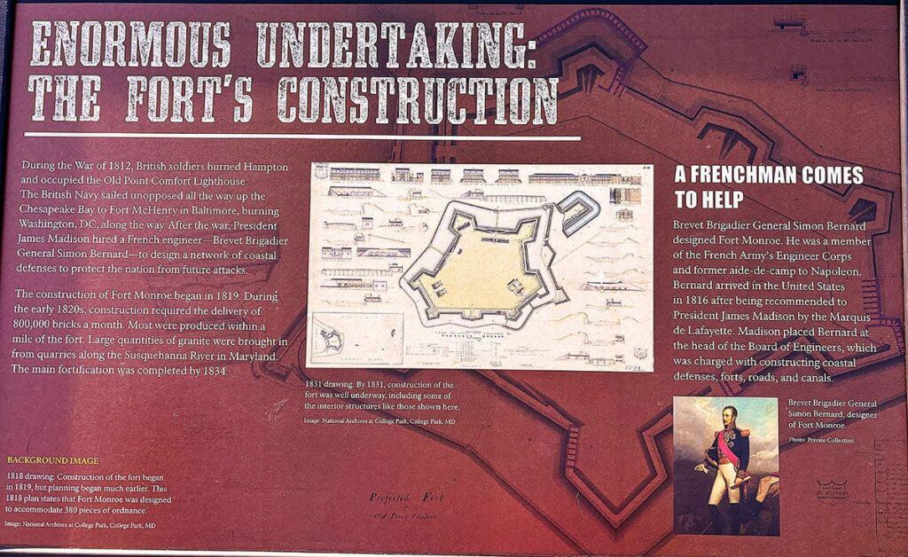 Historical display on the construction of Fort Monroe, featuring text and an architectural plan on a textured background.