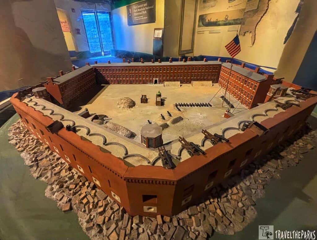 Model of Fort Sumter in 1861 with brick walls, cannons, and an American flag.