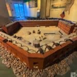 Model of Fort Sumter in 1861 with brick walls, cannons, and an American flag.