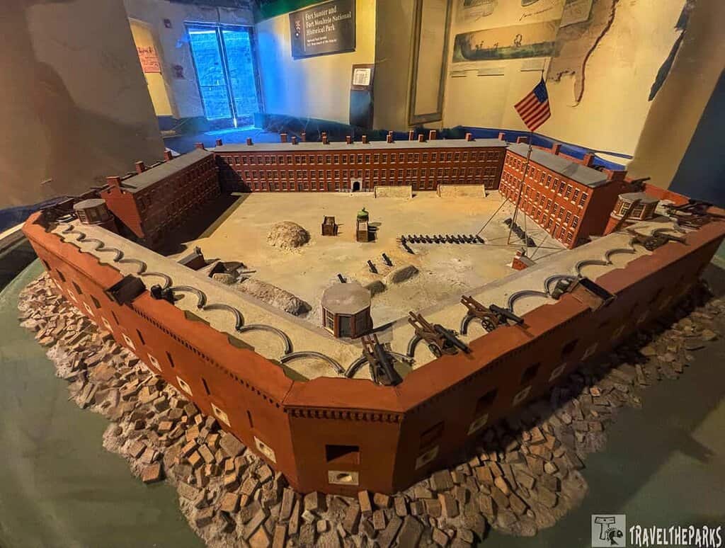 Model of Fort Sumter in 1861 with brick walls, cannons, and an American flag.