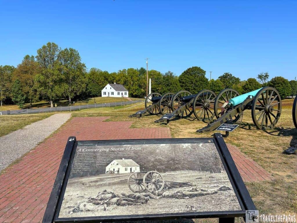 A historical site with a row of cannon replicas and Dunker Church in the background.