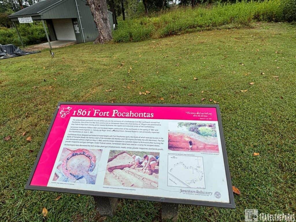 Informational sign about 1861 Fort Pocahontas on a grassy area near a small green building.