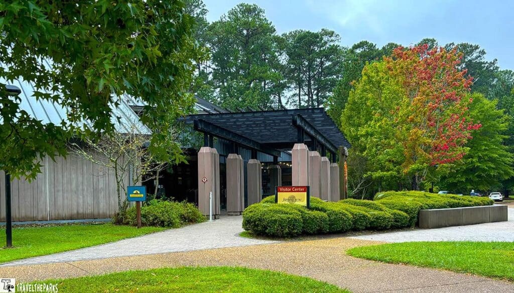 The Historic Jamestowne Visitor Center entrance surrounded by trees and shrubs.