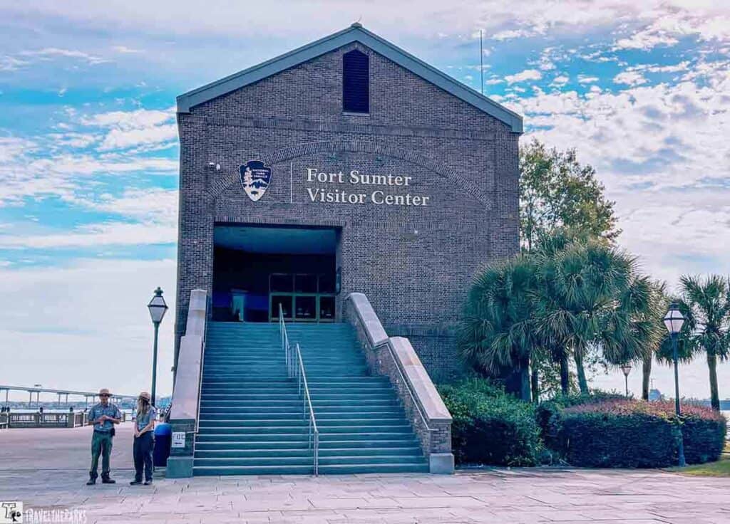 Fort Sumter Visitor Center with staircase entrance and surrounding greenery.