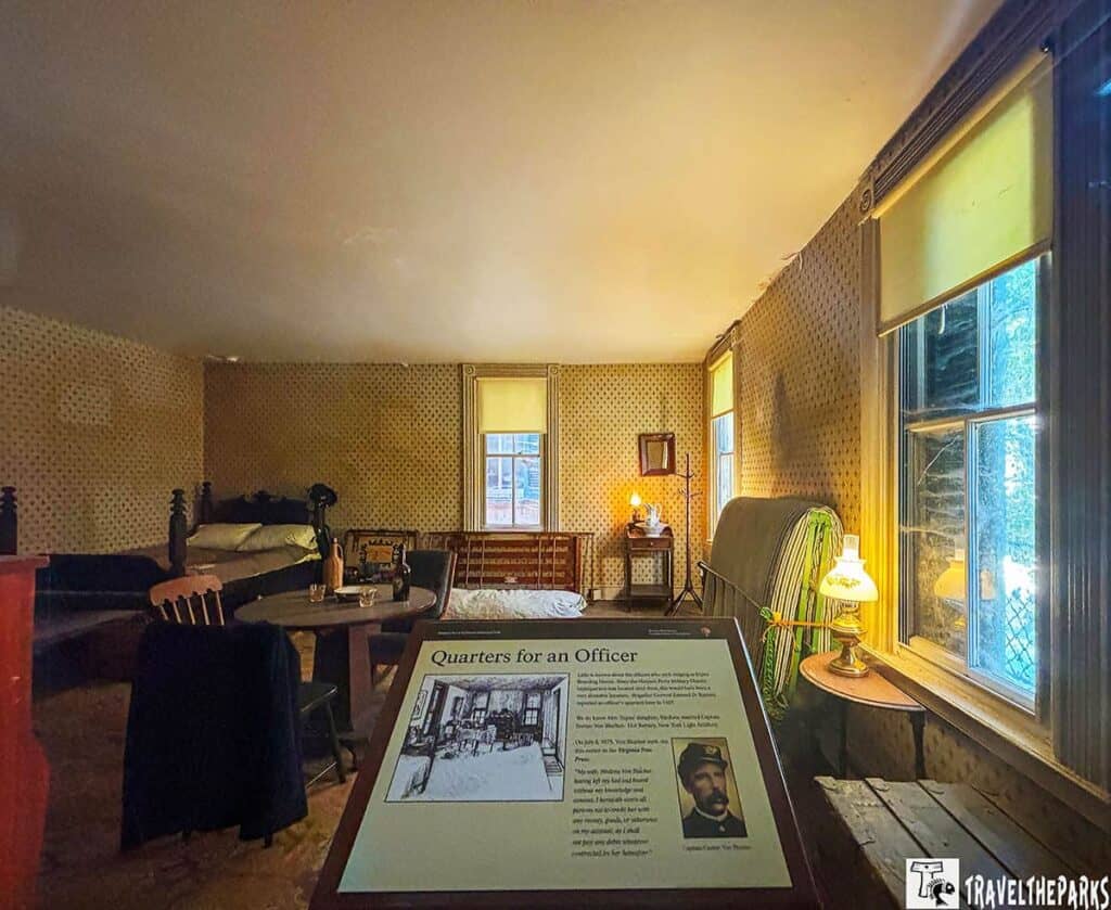 Historical room with vintage furnishings and a display titled "Quarters for an Officer."
