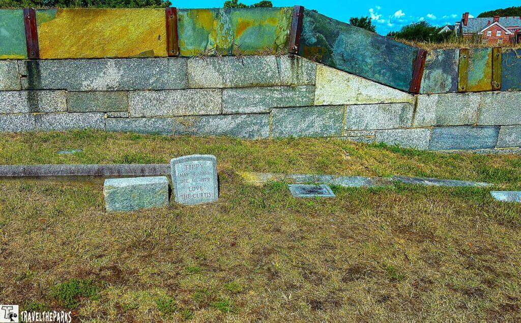 A stone wall and a pet gravestone at Fort Monroe.

