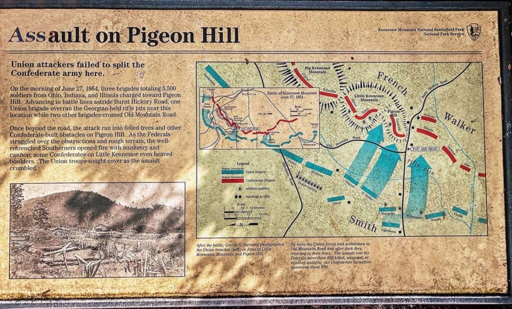 Interpretive panel titled "Assault on Pigeon Hill" with Civil War battle description and map at Kennesaw Mountain National Battlefield Park.