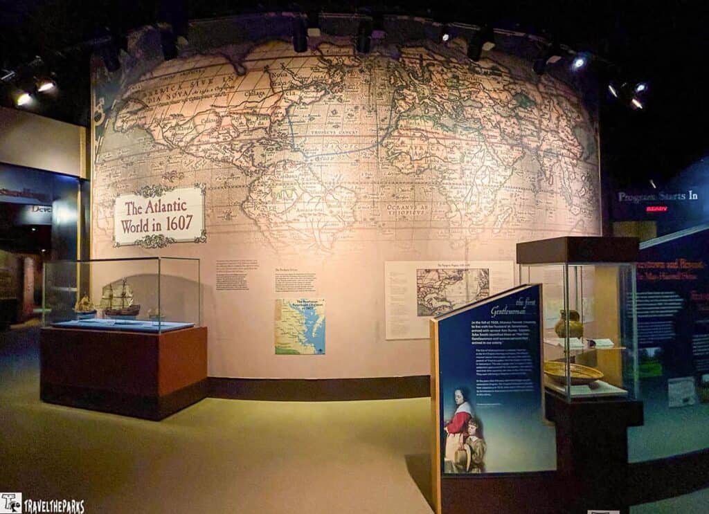 Museum exhibit with a large 1607 map of the Atlantic World and display cases with ship models and artifacts.