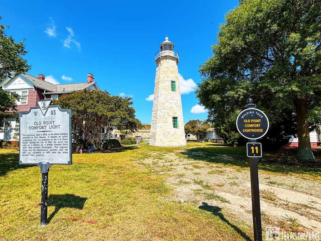 Old Point Comfort Lighthouse with historical marker and walking tour sign.