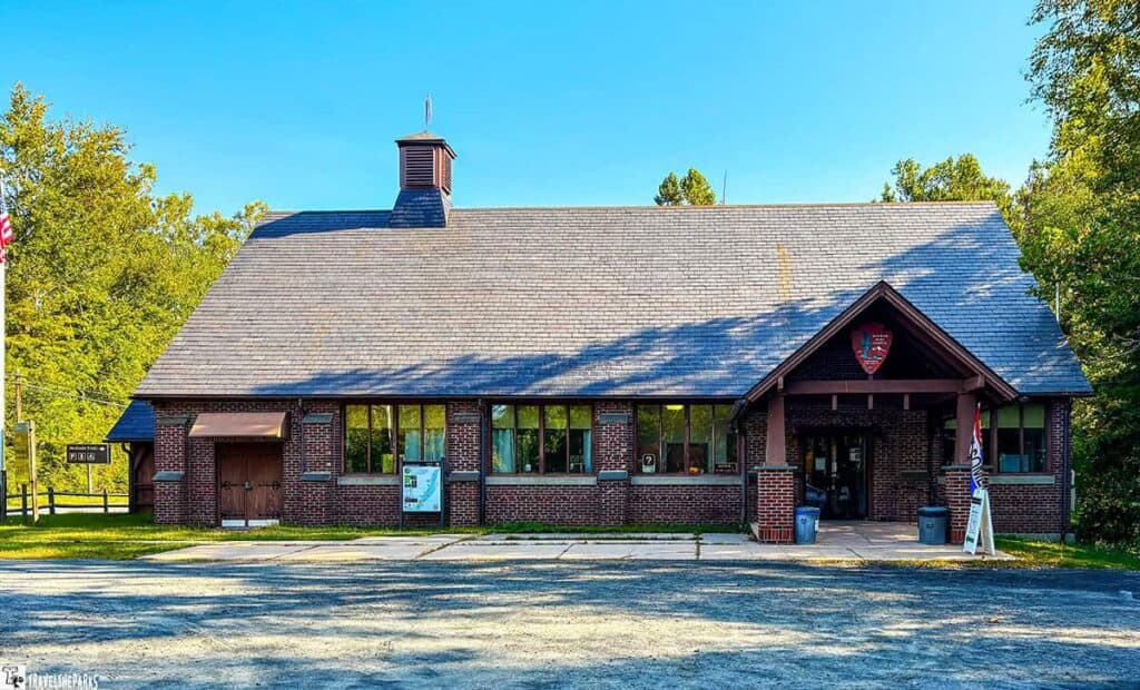 Bushkill Meeting Center in Delaware Water Gap National Recreation Area with red brick exterior and gray shingle roof.