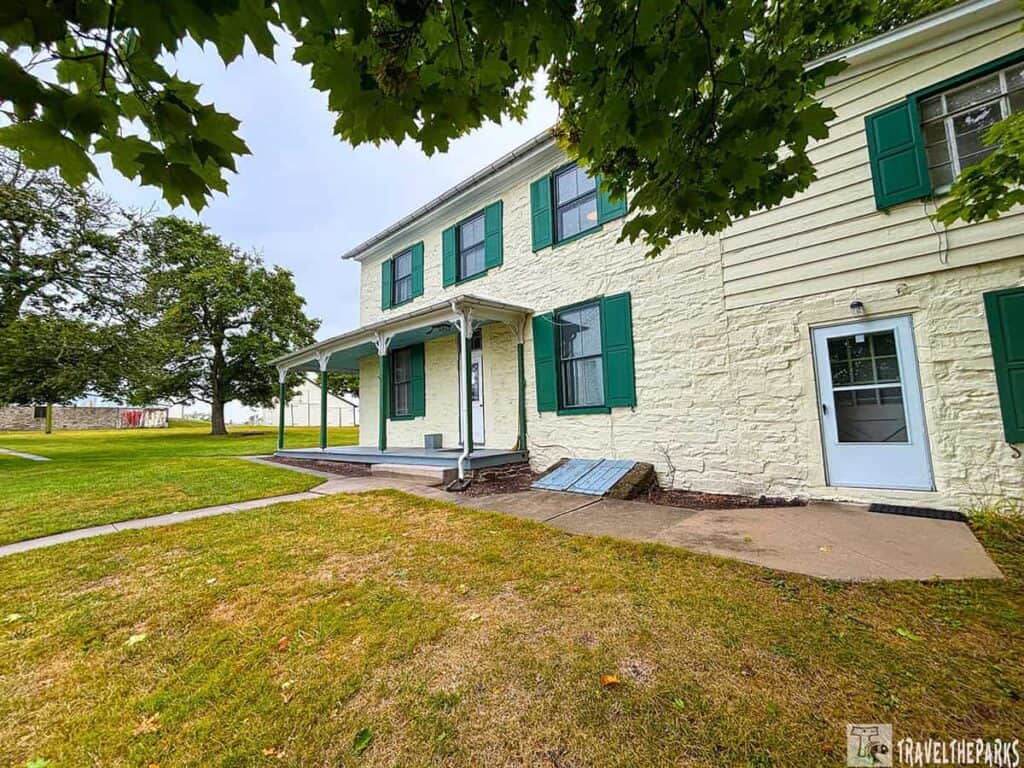 Herdman’s Home at Eisenhower National Historic Site, a cream-colored house with green shutters and a porch.