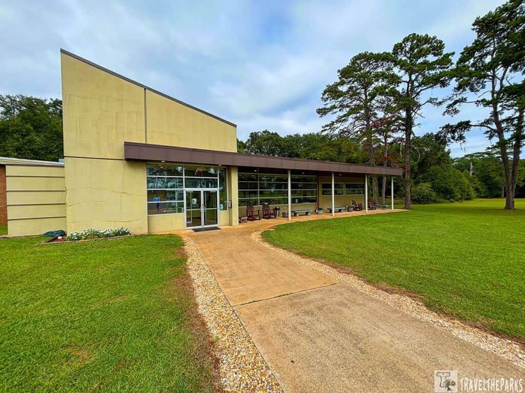 Exterior of the Kolomoki Mounds museum visitor center with a modern design and a manicured lawn.


