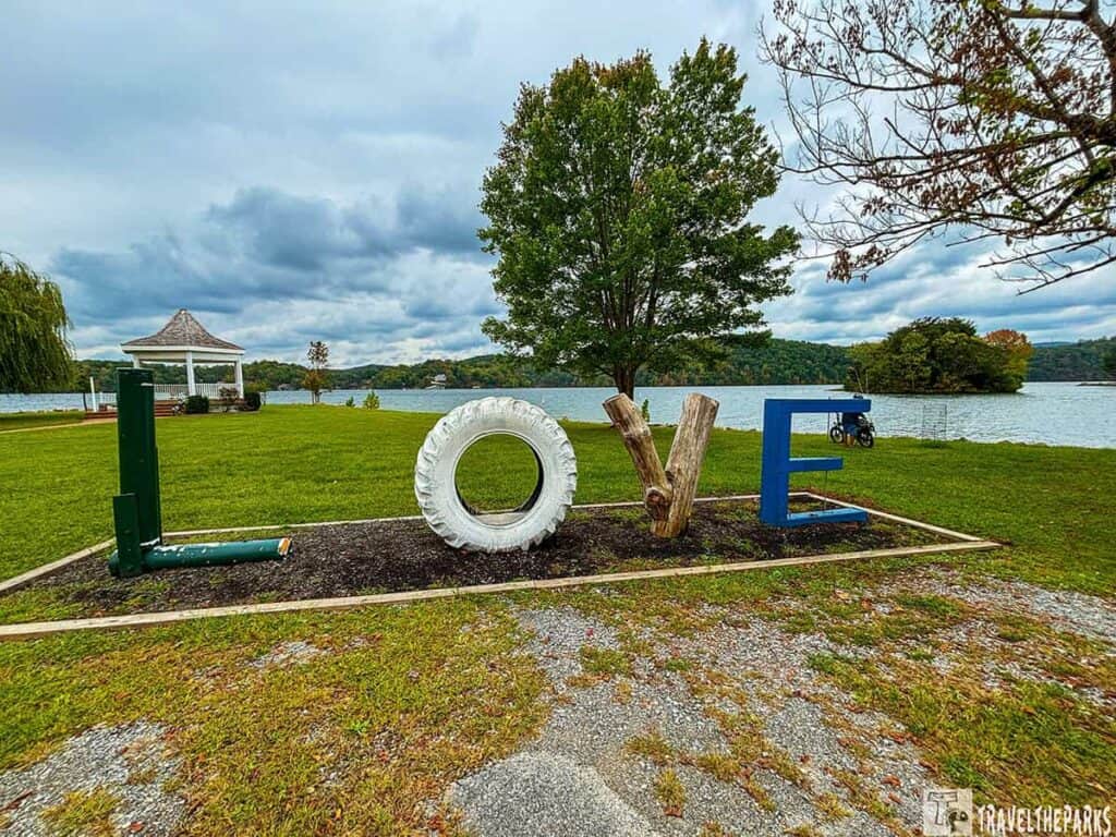 "LOVE" sculpture by the lakeside at Claytor Lake State Park with a gazebo and lake in the background.


