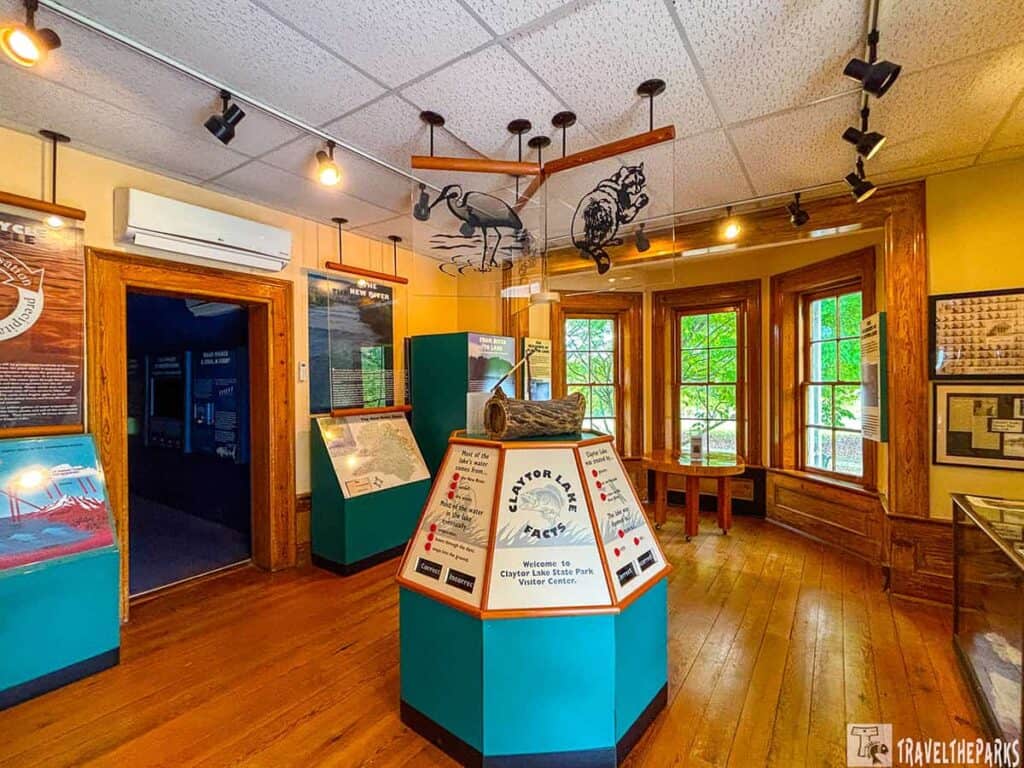 Interior view of a visitor center exhibit at Claytor Lake State Park with informational displays and large windows.

