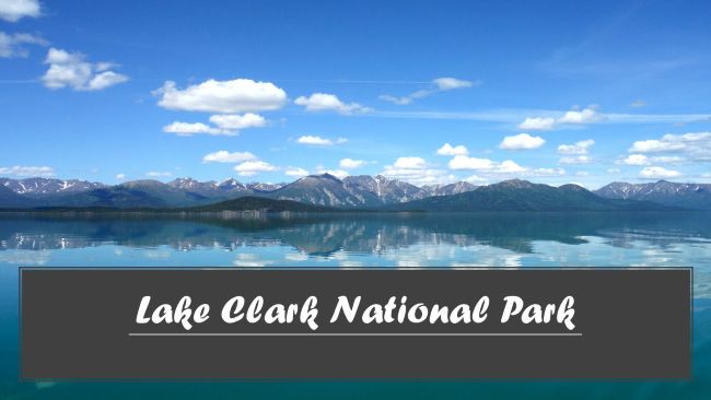 Lake with mountainous backdrop under a cloudy sky, banner reads "Lake Clark National Park".