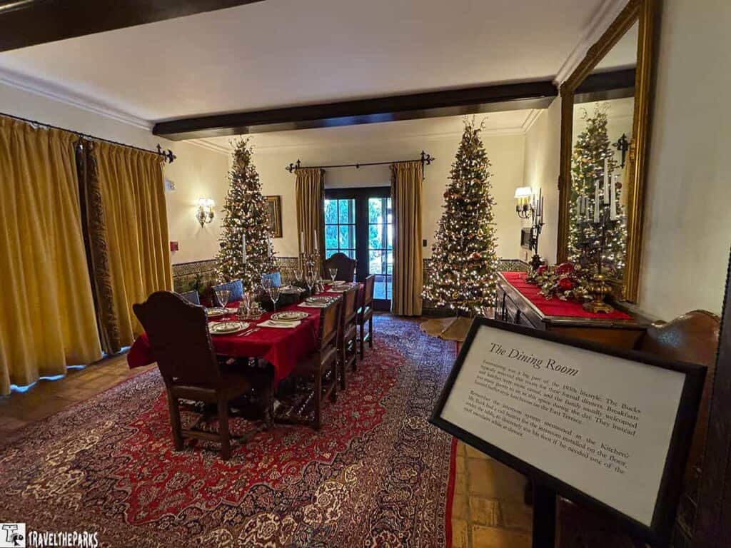 Elegantly decorated dining room with a festive table setting and Christmas trees at El Retiro mansion, Bok Tower.

