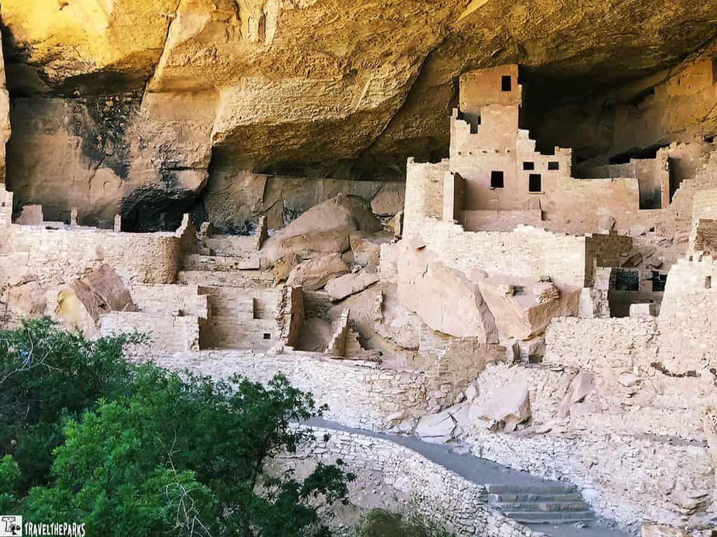 Ancient stone buildings of Cliff House granaries built into a cliff alcove.