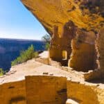 Ancient cliff dwellings at Balcony House, Mesa Verde, under a large sandstone overhang.