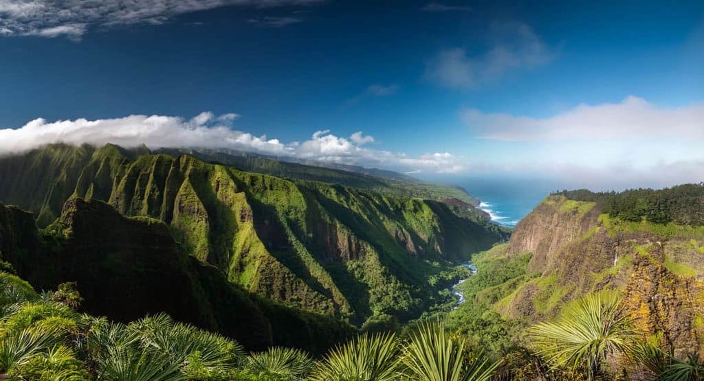 Epic Outdoor Adventures in Maui: Scenic overlook from Kauai mountains, featuring the lush, colorful valleys of Maui stretching out below.