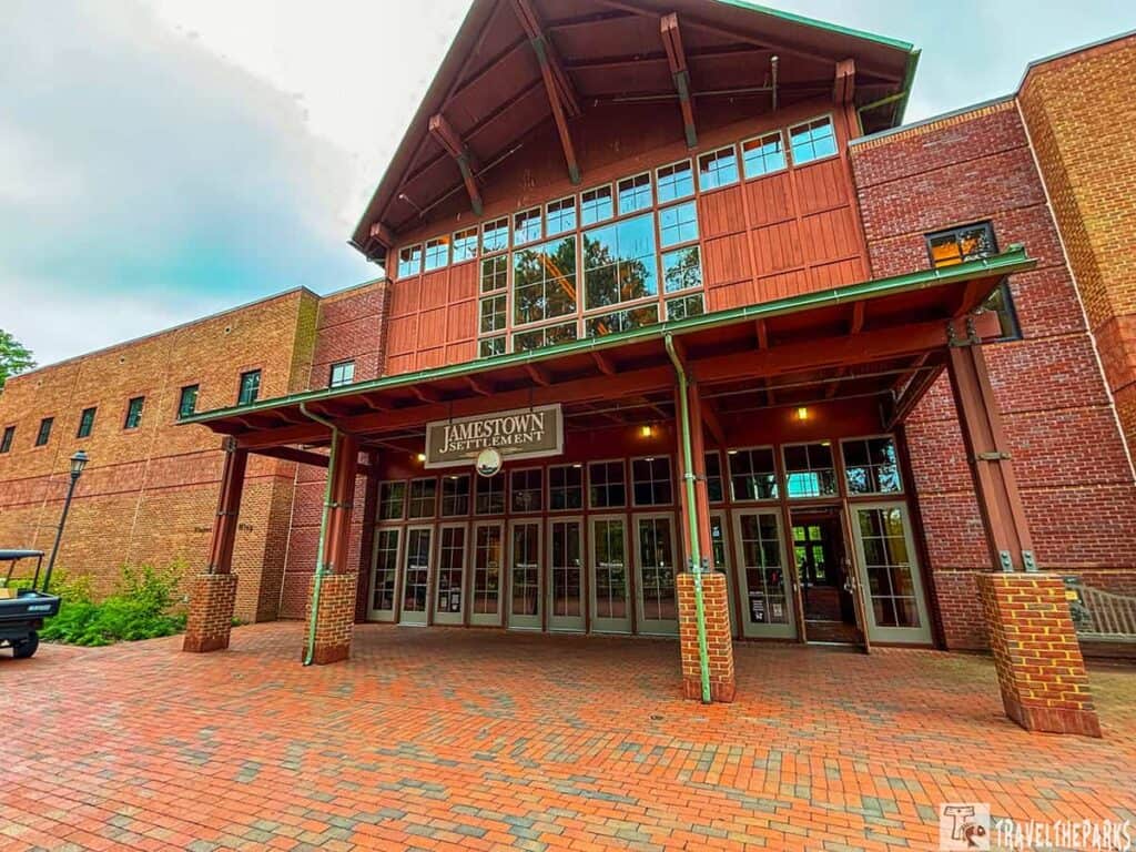 Entrance to Jamestown Settlement with brick facade and glass doors.

