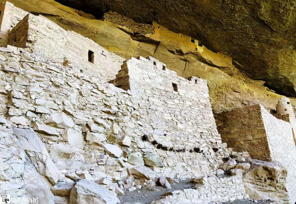 View of Cliff Palace at Mesa Verde, showcasing ancient stone structures built under a large rock overhang.

