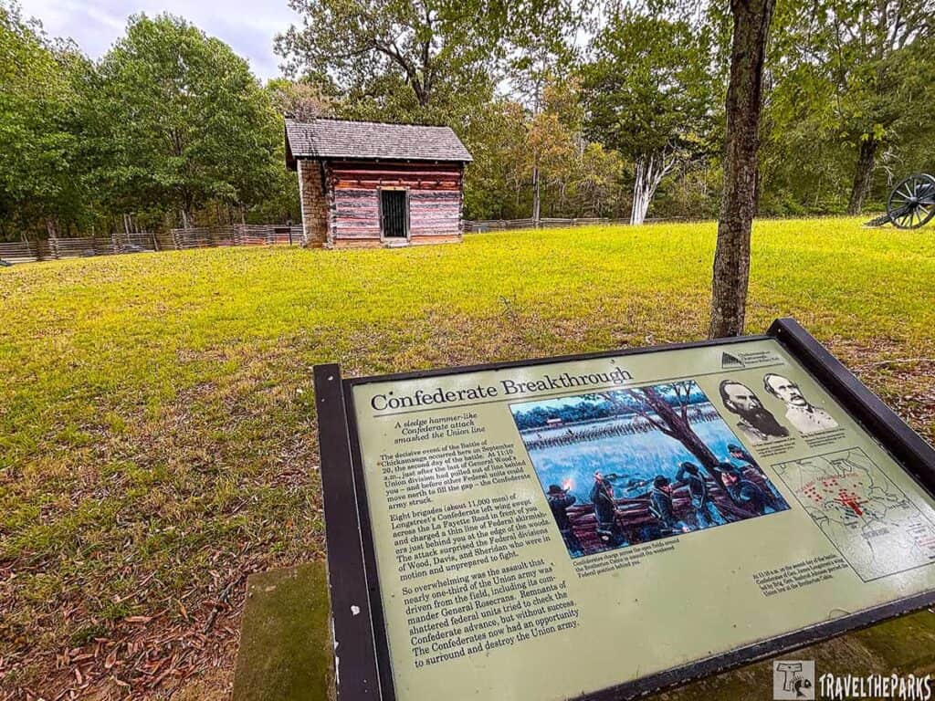 Brotherton log cabin at the Chickamauga and Chattanooga National Military Park with an informational sign in the foreground titled "Confederate Breakthrough."

