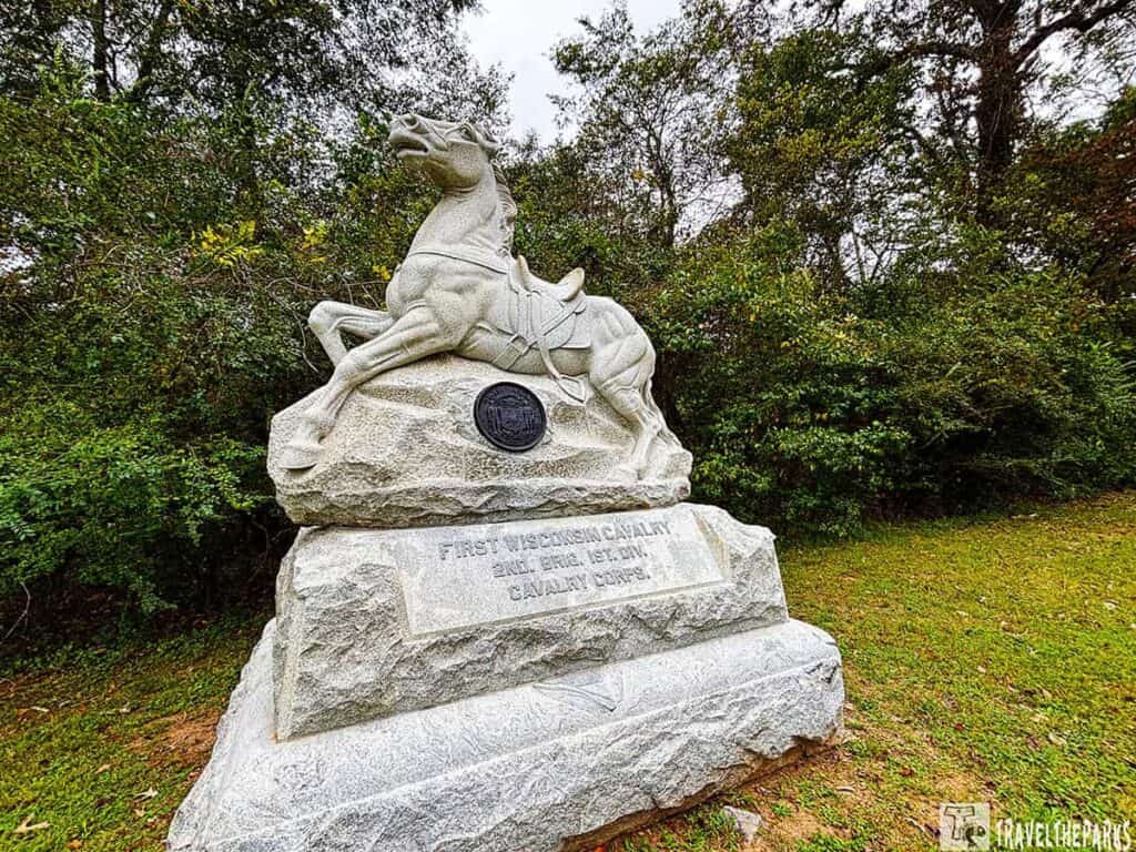 Monument of a rearing horse at the First Wisconsin Cavalry, Chickamauga Battlefield, surrounded by trees.


