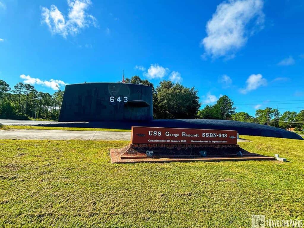 USS George Bancroft submarine sail with number 643 and a commemorative sign in front.