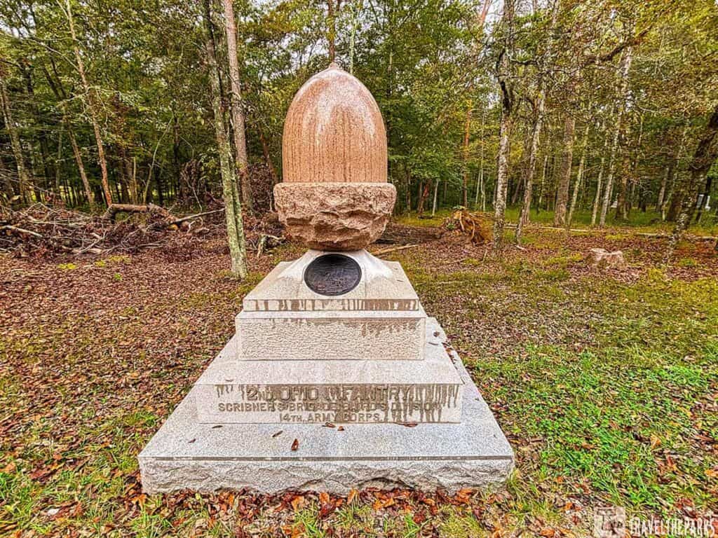 Monument to the 2nd Ohio Infantry at Chickamauga, featuring a stone artillery shell on a base surrounded by forest.

