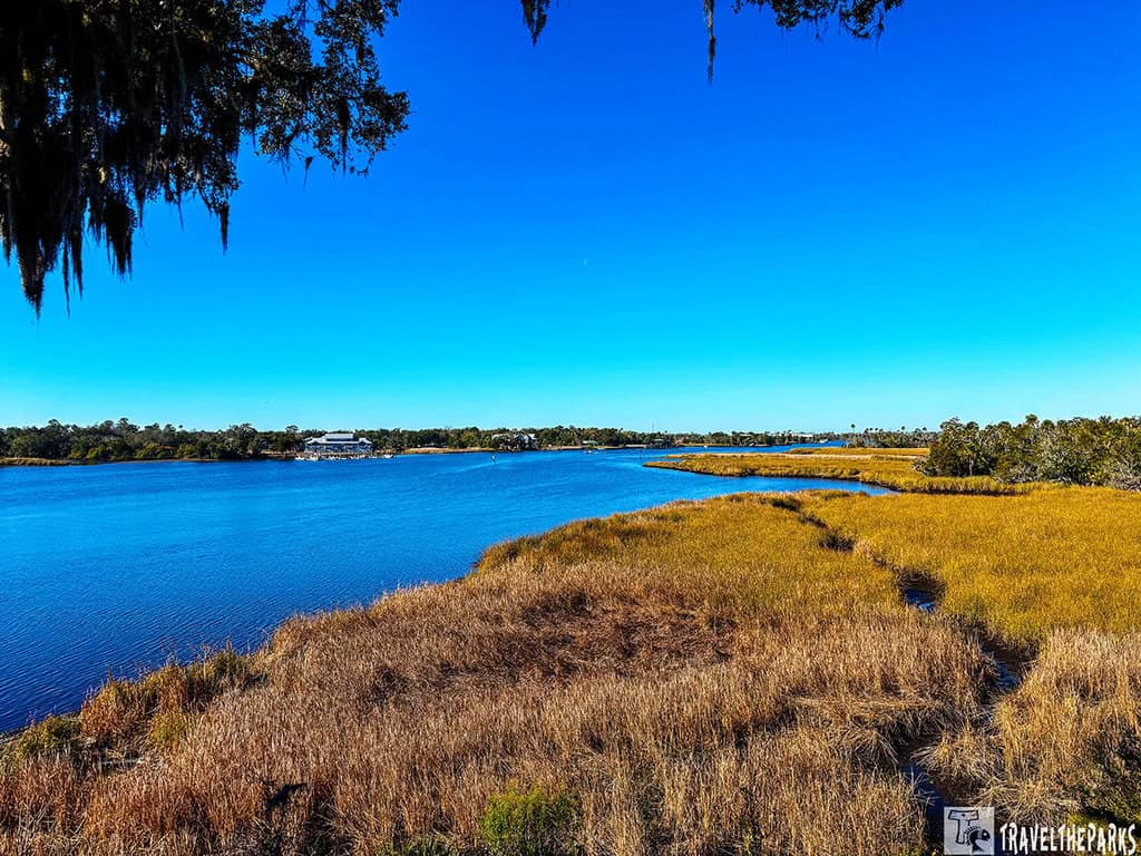Scenic view of a river from top of Temple Mound A with golden grasses in the foreground under a clear blue sky.