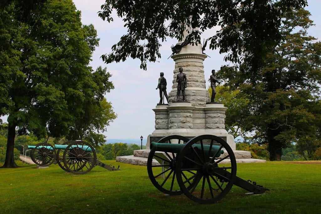 Bragg Reservation on Missionary Ridge-Monument with bronze statues and cannons on a grassy hill, surrounded by trees.