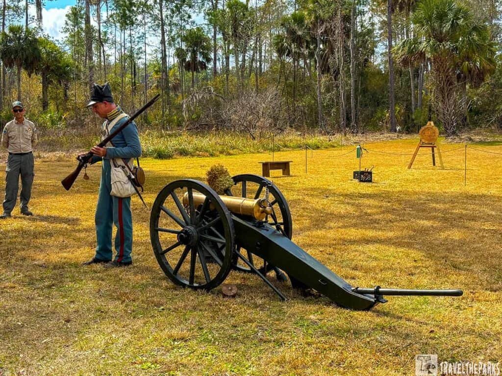 Reenactor in blue uniform beside a cannon at Fort Foster State Historic Site.