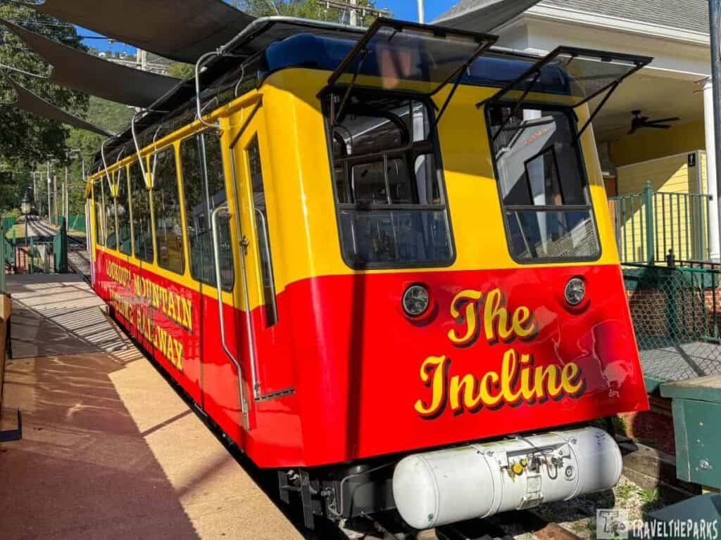 Red and yellow funicular train labeled "The Incline" at a station platform.