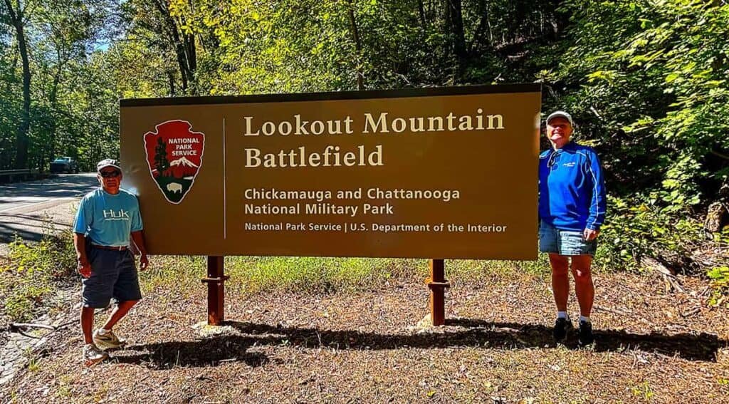 Sign for Lookout Mountain Battlefield with two people standing beside it.