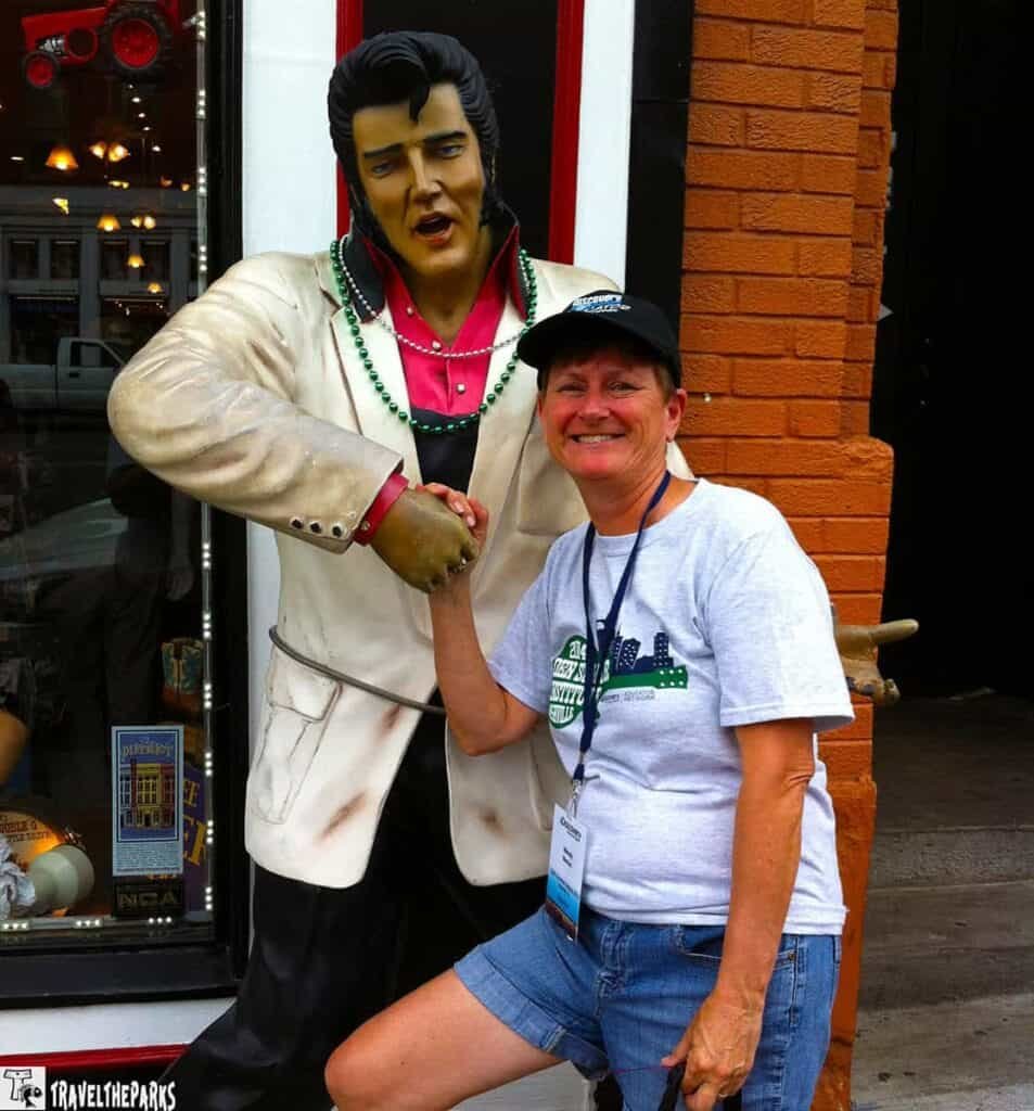 Downtown Nashville on our road trip. Shaking hands with a life-sized statue in a Elvis outside a brick building.on Broadway.