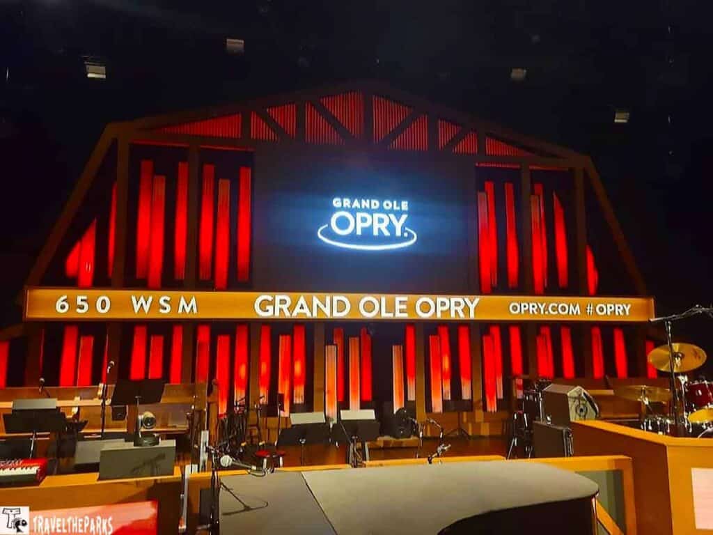 On our Nashville Weekend Road Trip. Stage of the Grand Ole Opry with red illuminated backdrop and the Opry logo displayed.
