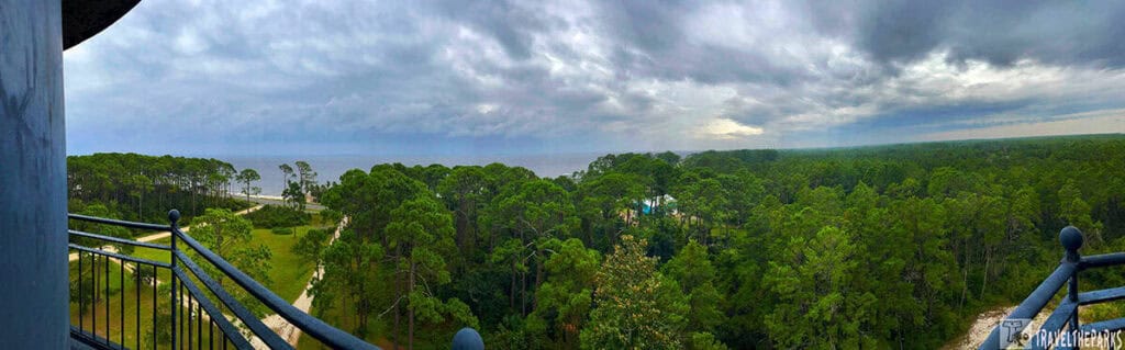 Panoramic view from a high vantage point of a forest with a cloudy sky.