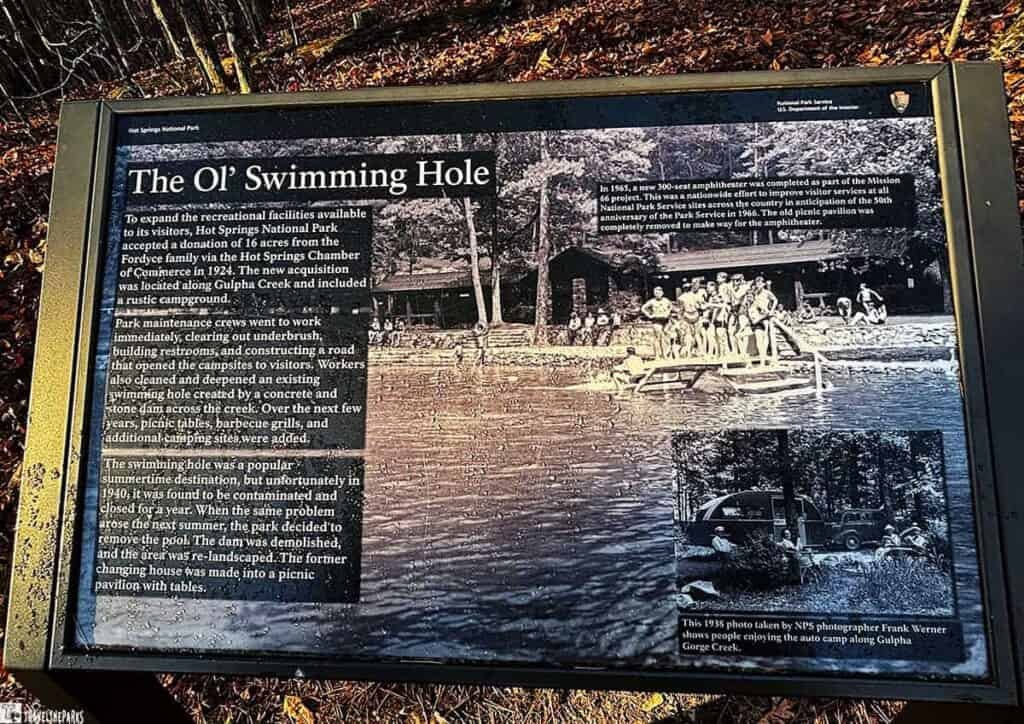 Informational display about "The Ol’ Swimming Hole" with historical photos and text at Hot Springs National Park.