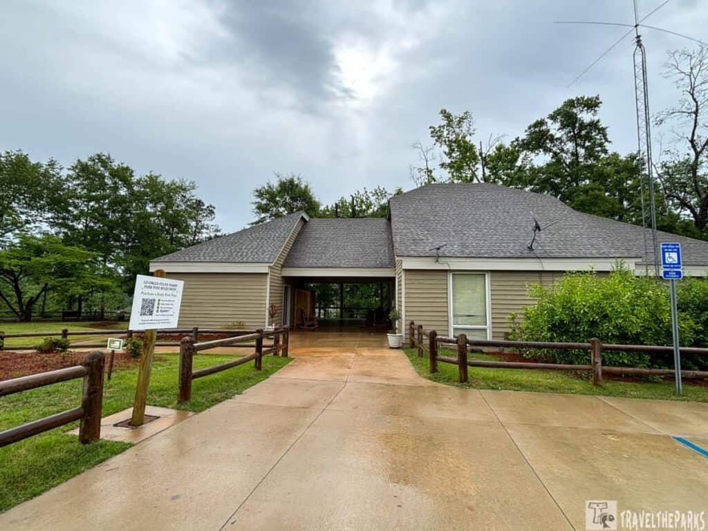 Providence Canyon visitor center with a fenced pathway and overcast sky.