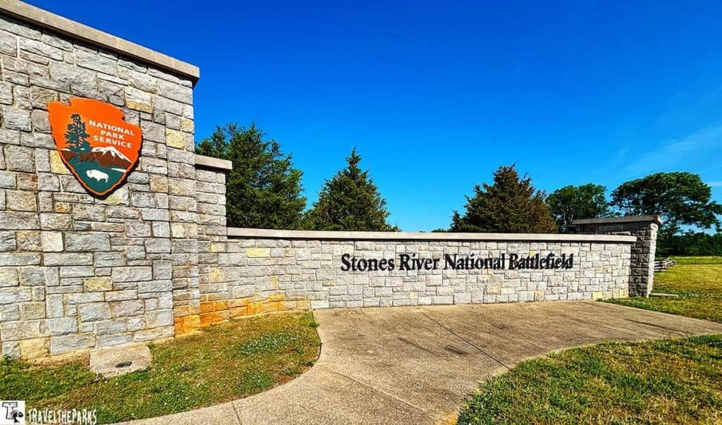Entrance sign of Stones River National Battlefield featuring a stone wall and National Park Service emblem.

