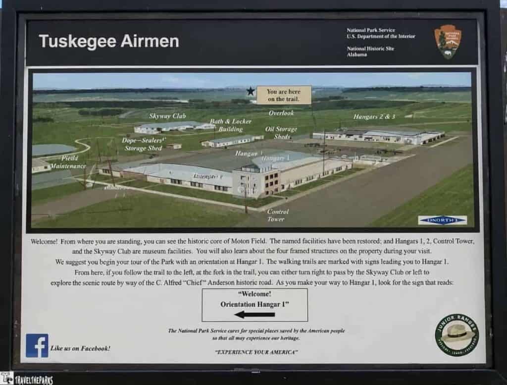 Map of the Tuskegee Airmen National Historic Site showing various facilities, including Hangars and the Control Tower, with directional information for visitors.

Transcribed Text:
Welcome! From where you are standing, you can see the historic core of Moton Field. The named facilities have been restored; and Hangars 1, 2, Control Tower, and the Skyway Club are museum facilities. You will also learn about the four framed structures on the property during your visit.
We suggest you begin your tour of the Park with an orientation at Hangar 1. The walking trails are marked with signs leading you to Hangar 1.
From here, if you follow the trail to the left, at the fork in the trail, you can either turn right to pass by the Skyway Club or left to explore the scenic route by way of the C. Alfred “Chief” Anderson historic road. As you make your way to Hangar 1, look for the sign that reads:
“Welcome!
Orientation Hangar 1”
The National Park Service cares for special places saved by the American people so that all may experience our heritage.
“EXPERIENCE YOUR AMERICA”