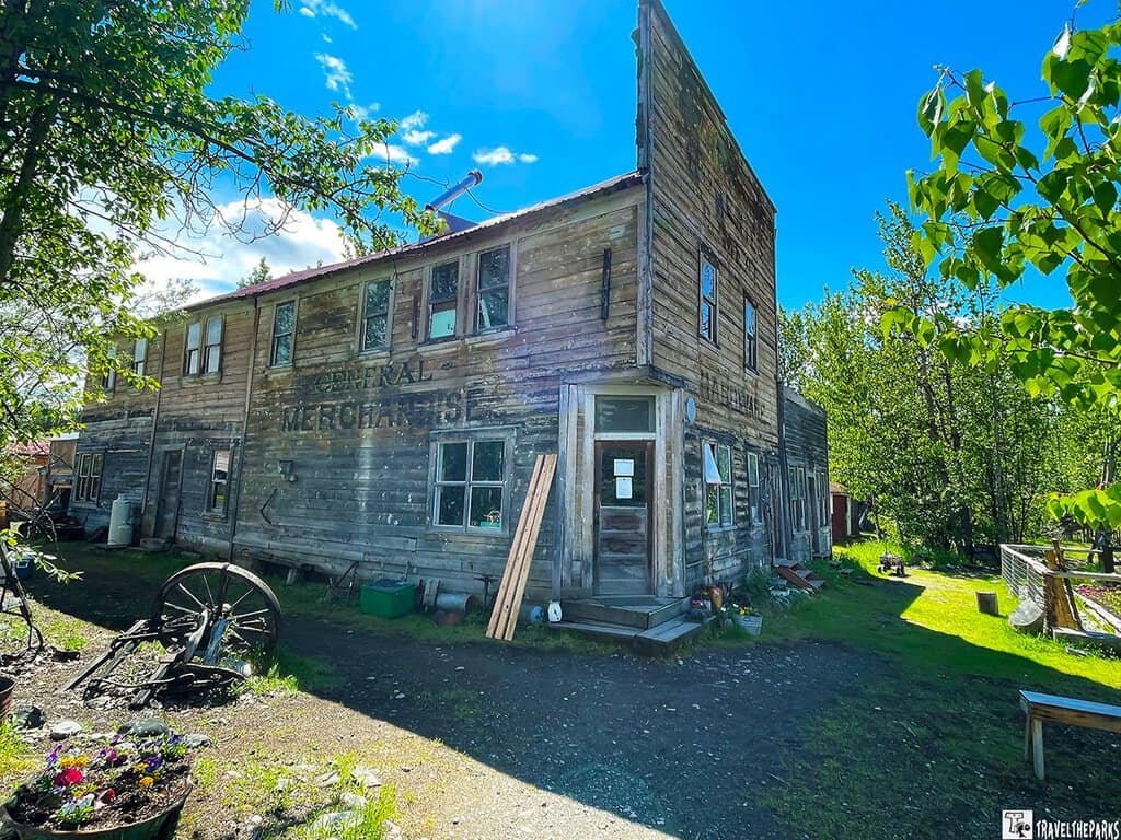 McCarthy Mercantile Building: Old wooden two-story building with faded signage and rustic surroundings under a blue sky.