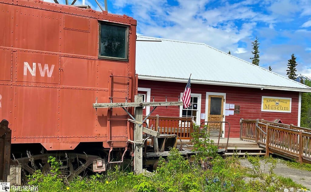 McCarthy Museum: A red train car next to a small red museum building with an American flag.